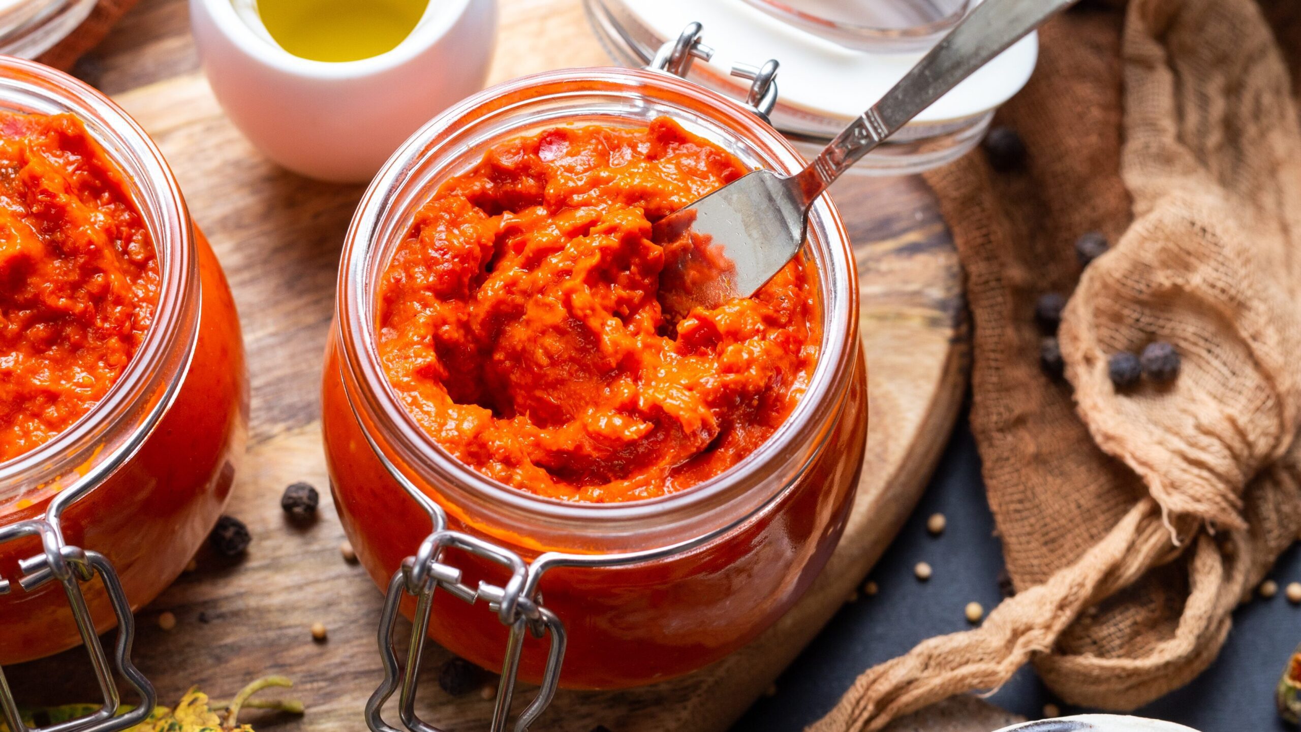 closeup raw ajvar table with vegetables sauces background edited scaled
